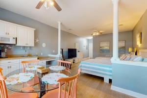 a kitchen and dining room with a table and chairs at Sea Trail Golf-Beach Mini Suite in Sunset Beach
