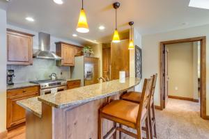 a kitchen with a large island with bar stools at Central McCall Getaway Walk to Payette Lake! in McCall