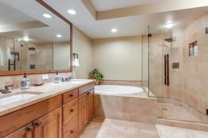a bathroom with a tub and a sink and a shower at Central McCall Getaway Walk to Payette Lake! in McCall +23 photos