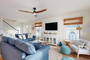 a living room with a blue couch and a tv at South Bethany --- 106 Brandywine Drive in Bethany Beach