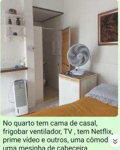 a room with a bed and a fan on a dresser at Cantinho da casa verde em Praia Seca in Araruama
