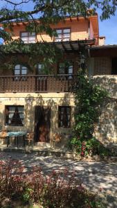 a building with two animals sitting in front of it at La Calleja de Ucieda Balcon in Ucieda de Arriba