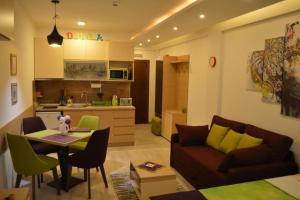 a living room with a couch and a table at Apartman S32 Milmari in Raška