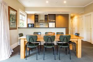a kitchen and dining room with a wooden table and chairs at The White Swan Hotel in Greytown
