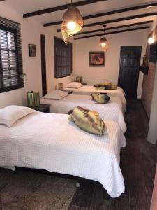 a group of four beds in a room at Casa frente al mar playa Chicama, Puerto Malabrigo in Puerto Chicama