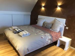 een slaapkamer met een bed met twee kussens erop bij L'estive gîte 4 étoiles in Nasbinals