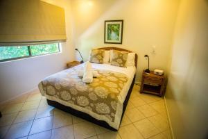 A bed or beds in a room at Melaleuca Resort