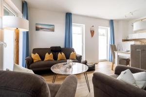 a living room with a couch and a table at Nordsee Oase 50 0 N in Wangerland