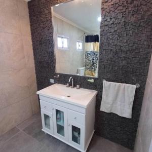 a bathroom with a white sink and a mirror at Naturaleza Necochea in Necochea