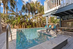 a swimming pool with a bench next to a house at 118 E Whiting St B Side in South Padre Island