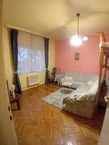 A bed or beds in a room at Mozaik Apartman