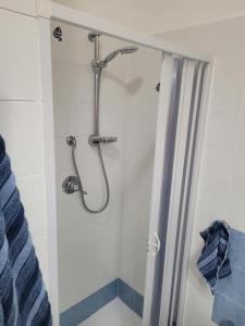 a shower in a bathroom with a shower curtain at Casa Orchidea in Castelsardo +13 photos