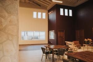 a dining room with tables and chairs and windows at Casa Zamora in Villa de Juárez