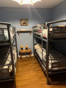 a room with three bunk beds and a table at Résidence Marmottes Ii - 3 PIECES 6 PERSONNES MAE-7501 in Orcières