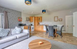 a living room with a couch and a table at Countryside Annexe, with hottub, sleeps up to 4 in Durston