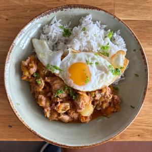 a plate of food with an egg and rice at Klausturhof Guesthouse in Kirkjubæjarklaustur