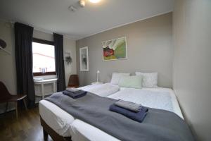 a bedroom with a large bed with two towels on it at Klausturhof Guesthouse in Kirkjubæjarklaustur