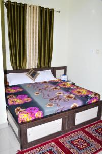 a bed sitting in a room with at Devholiday Home in Sawāi Mādhopur