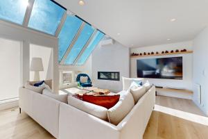 a living room with a white couch and a table at Snowfall Sanctuary, Unit 12 in Vail