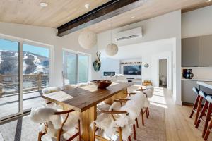 a kitchen and dining room with a wooden table and chairs at Snowfall Sanctuary, Unit 12 in Vail