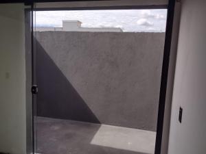 an open door to a window with a view of a building at Loft aconchegante in Ilhota