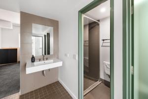 a bathroom with a sink and a mirror at YHA Sydney Harbour in Sydney +37 photos