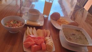 a table with plates of food and a cup of coffee at Hotel Santa Barbara Sachica in Villa de Leyva +16 photos