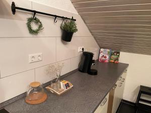 a kitchen counter with a coffee maker and plants on it at Familiennest Blaustein-Ulm Hunde auf Anfrage in Blaustein