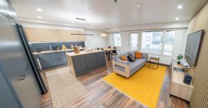a living room with a couch and a kitchen at City Luppo - Spacious, Smart, Warm, Sauna, Wi-Fi in Rovaniemi