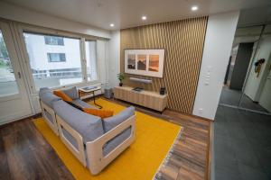 a living room with a couch and a table at City Luppo - Spacious, Smart, Warm, Sauna, Wi-Fi in Rovaniemi