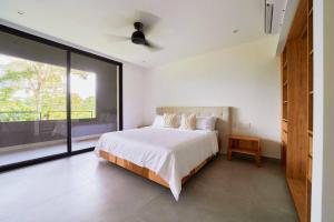 a bedroom with a bed and a large window at Casa Diwo in Puerto Viejo +46 photos