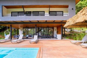 a villa with a swimming pool and a patio at Casa Diwo in Puerto Viejo