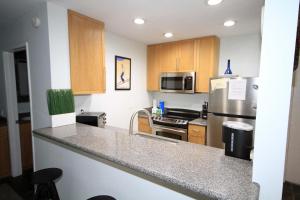 a kitchen with stainless steel appliances and wooden cabinets at Summit 285 1 bedroom 1 bathroom - Pet Friendly in Mammoth Lakes