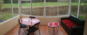 a room with a couch and a table and windows at PIC RIDER in Massy