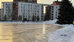 an empty parking lot in front of a large building at City Luppo - Spacious, Smart, Warm, Sauna, Wi-Fi in Rovaniemi