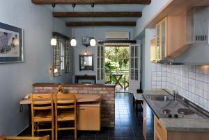 a kitchen with a table and a counter top at Villa Yannis in Kato Korakiana
