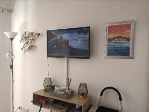 a living room with a tv on a wall at CORSALILA in Calvi