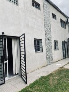 a large white building with a door open at Departamento 2 - Villa Z in Villa Zorraquín