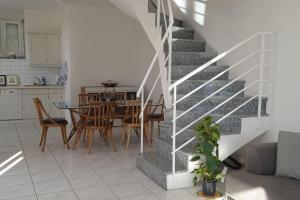 a kitchen and dining room with a staircase in a house at La Perla di Bre' in Aldesago