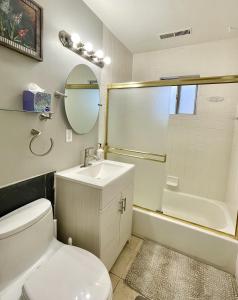 a bathroom with a toilet and a sink and a shower at Homestead Haven in Concord