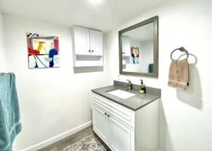 a bathroom with a sink and a mirror at Homestead Haven in Concord