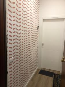 a hallway with a white patterned wall at Soria Home-A due passi da Centro e Mare in Pesaro +26 photos
