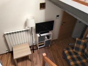 a living room with a flat screen tv and a chair at La Baita in Pratola Peligna