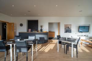 a dining room with black tables and chairs at Volcano Hotel in Vík