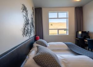 a hotel room with two beds and a window at Volcano Hotel in Vík