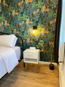 a bedroom with a wall with a floral wallpaper at Luxury Boutique Home - 5 Beds 2 Baths 25 minutes to NYC in Jersey City