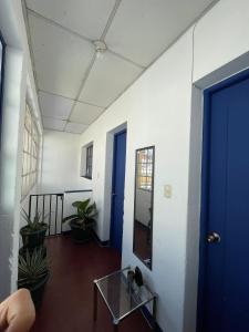 a room with a blue door and a glass table at Casa Bienestar in Guatemala +49 photos