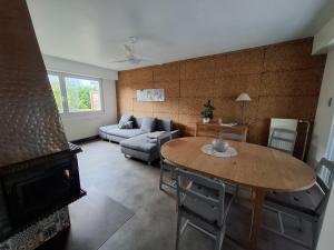 a living room with a table and a couch at Charmante maison familiale in Rixheim