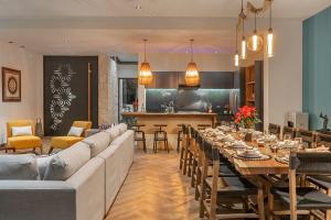 a living room with a long couch and a table at Oceanview villa 4BR Concierge Service in Tulum
