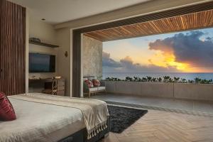 a bedroom with a view of the ocean at Oceanview villa 4BR Concierge Service in Tulum